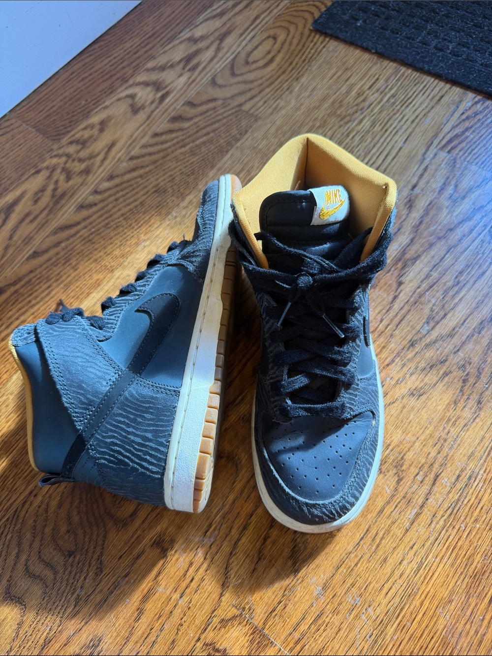 Woman’s Black and Yellow High-Top Sneakers